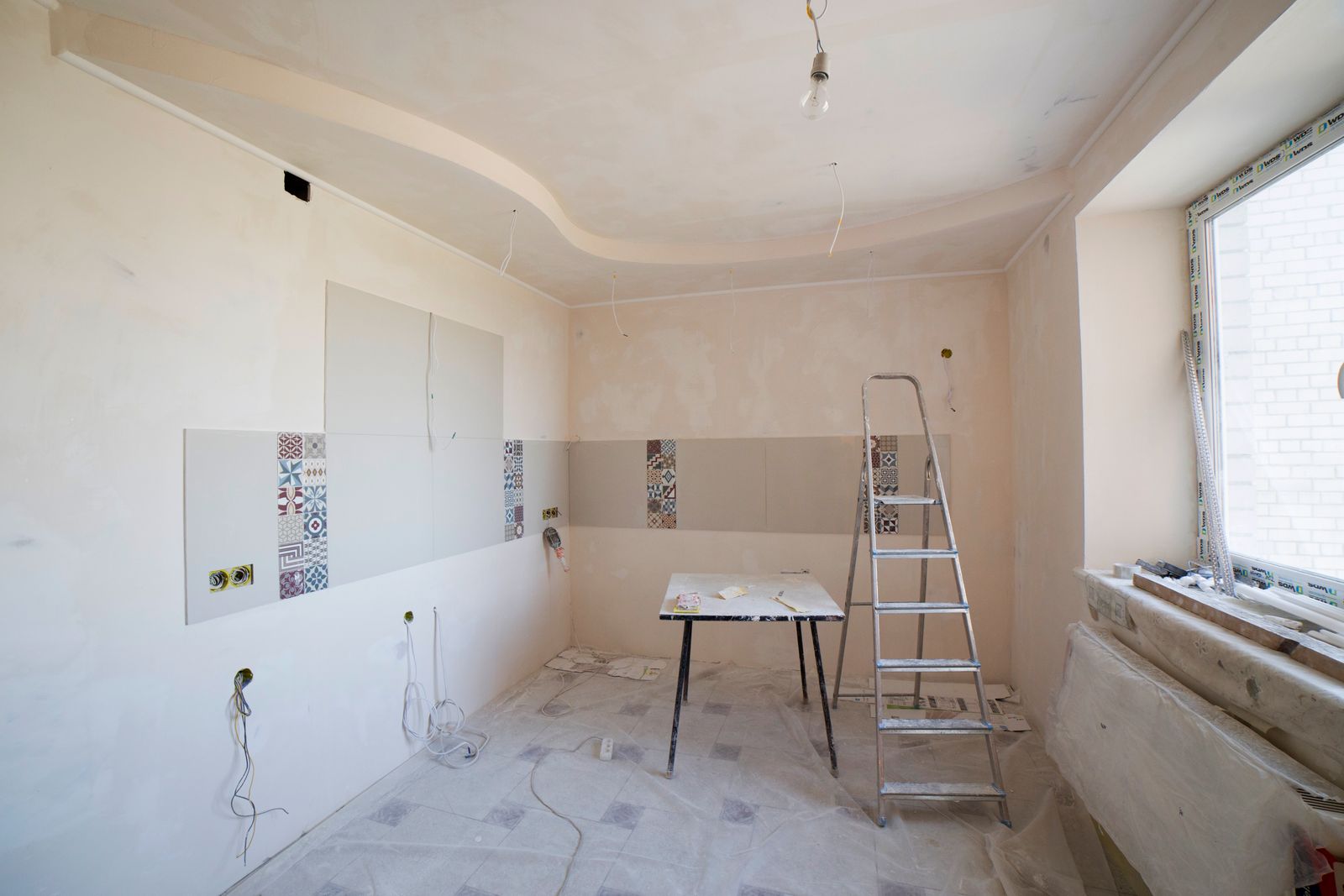 Kitchen before renovation, stripped back to bare walls
